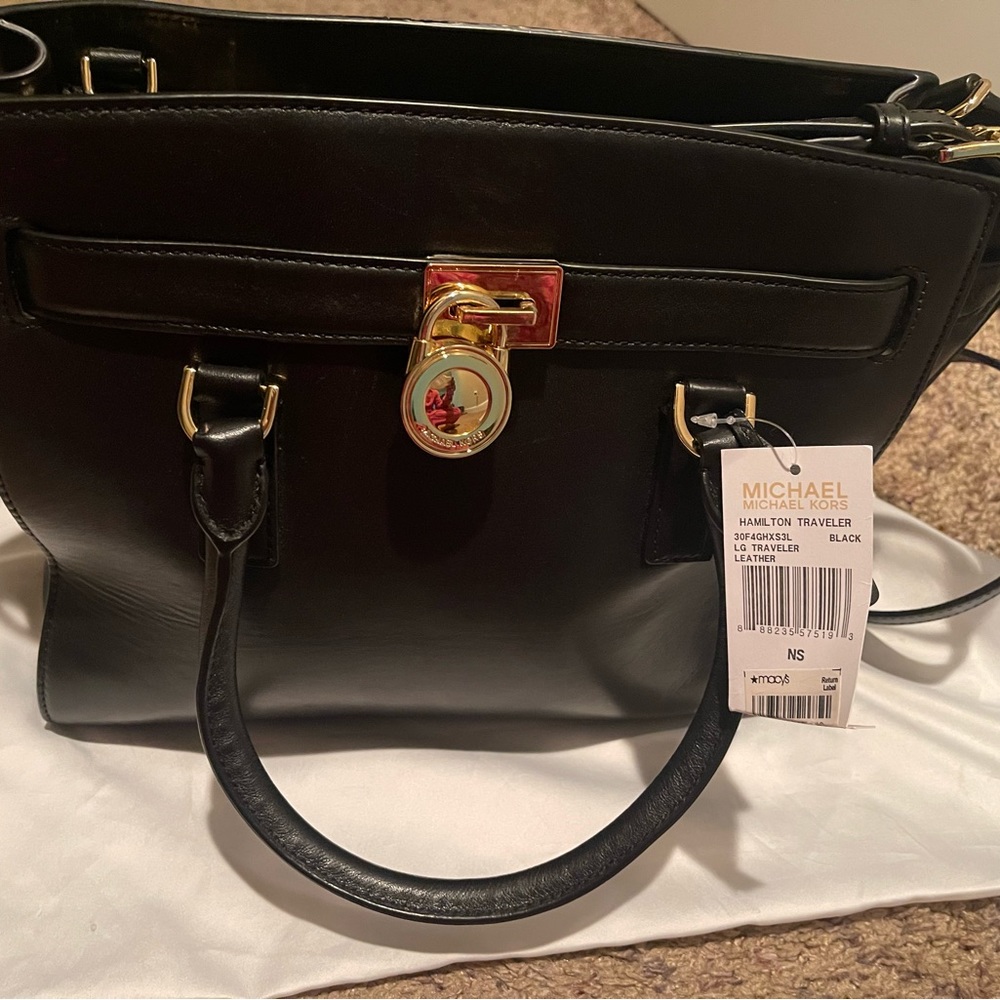 Brand new.Very light mark next to the MK logo.Very hard to see.